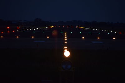 Reflection of illuminated water in sky at night