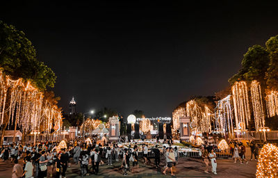 Group of people in front of buildings at night