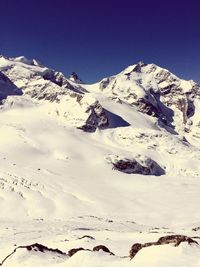 Scenic view of snow covered mountains