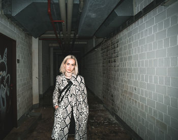 Portrait of young woman standing in tunnel