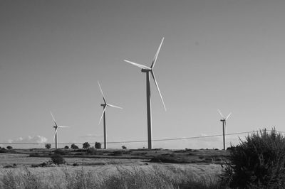 Windmill on field against sky