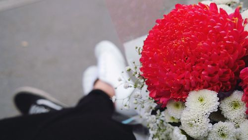 Low section of woman with flower bouquet