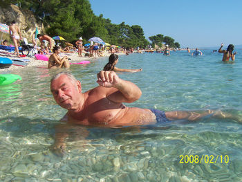 Tourists swimming in sea