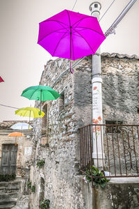 Low angle view of umbrella on building against sky