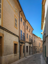 Street amidst buildings in town against sky