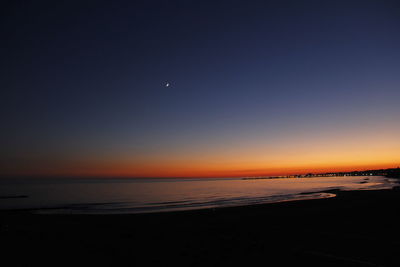 Scenic view of sea against clear sky at sunset