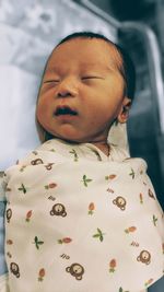 Cute boy sleeping on bed