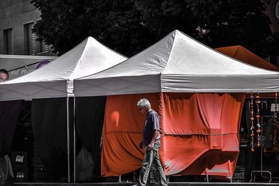 Rear view of men working in tent