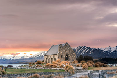 Sunrise view of the church of good shepherd with beautiful snow capped mountain range. 