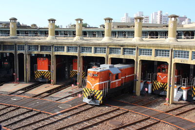 Train by railroad tracks against clear sky