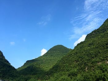 Low angle view of mountain range against blue sky