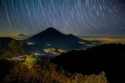 Scenic view of silhouette mountains against sky at night