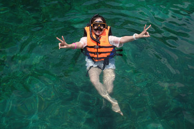 High angle view of young woman in sea