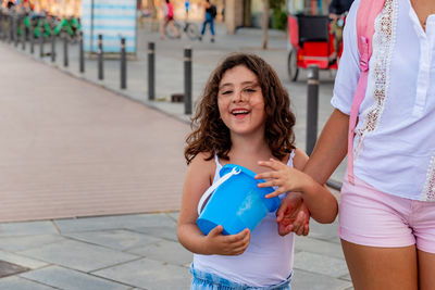 Mother and daughter walking to the beach