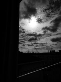 Silhouette of building against cloudy sky