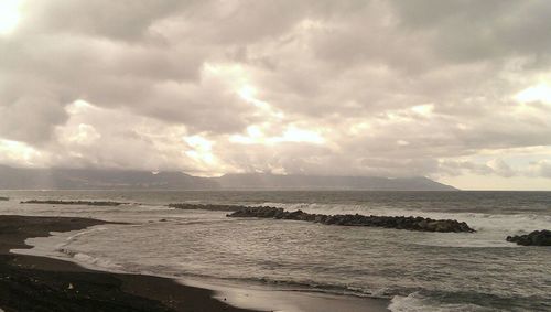 Scenic view of sea against cloudy sky