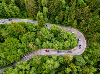 Aerial view of countryside road passing through the forest and mountain