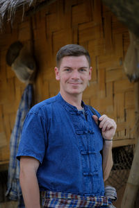 Portrait of smiling young man standing outdoors