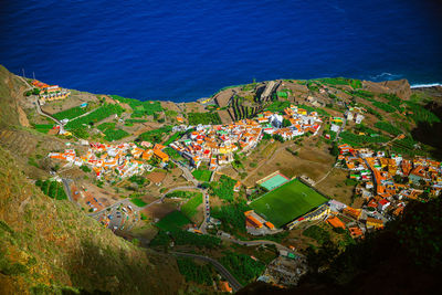 High angle view of townscape by sea