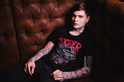 Mid adult man wearing hat against gray background