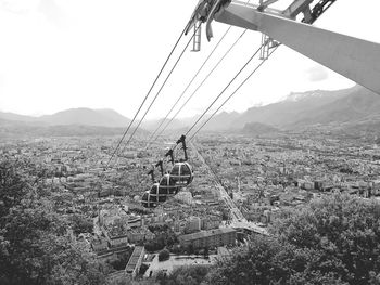 Overhead cable car over mountains against clear sky