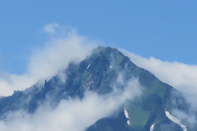 Low angle view of snowcapped mountains against sky