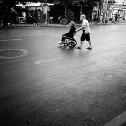 People riding motorcycle on street in city