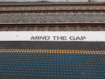 High angle view of text on railroad station platform