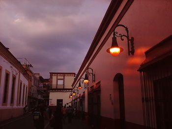 Illuminated street light in old town at dusk