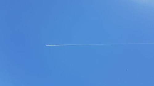 Airplane flying against clear blue sky