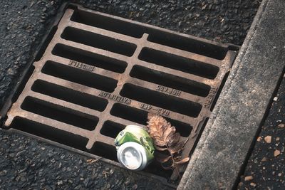 High angle view of metal grate on street