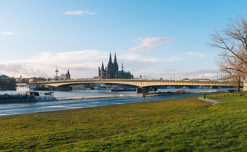 Deutz suspension bridge over rhine river with cologne cathedral against sky