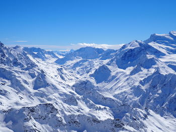 Scenic view of snowcapped mountains against clear sky