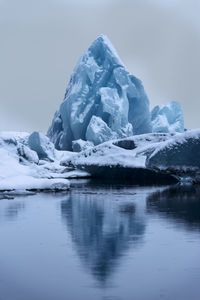 Scenic view of frozen lake against sky during winter