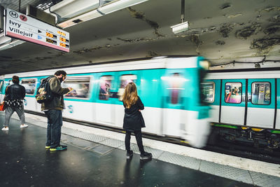 People on train at railroad station platform