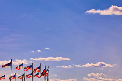 Low angle view of flag against blue sky