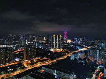 High angle view of illuminated buildings against sky at night