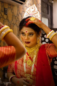 Portrait of young woman getting ready for her wedding