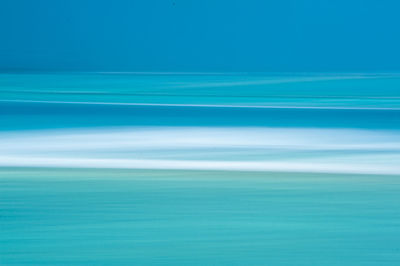 Scenic view of sea against blue sky