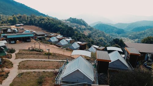 High angle view of houses and trees against sky