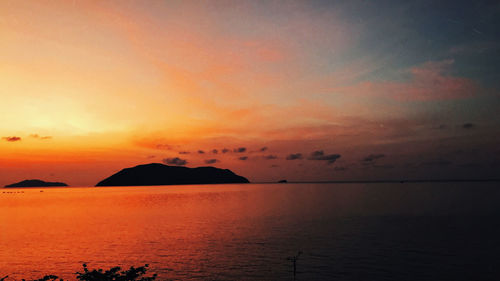 Scenic view of sea against orange sky