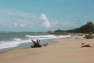 View of beach against cloudy sky