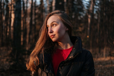 Young woman standing in forest