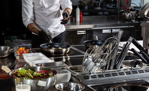 Midsection of man preparing food