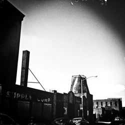 Low angle view of crane against sky