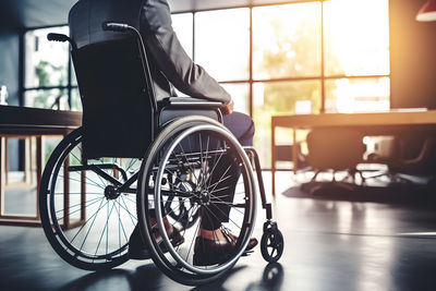 Low section of woman sitting on wheelchair