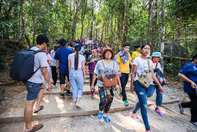 Group of people standing against trees