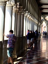 Full length of woman standing by railing