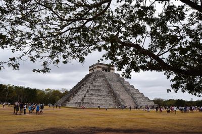 Group of people in front of historical building chichen itza