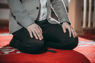 Midsection of women sitting on floor